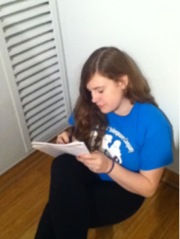 Sophomore Kate Cognard-Black writes a poem at the poetry workshop.