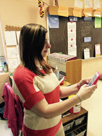 English teacher Ms. Wogman uses her new iPhone 6.