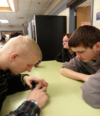 Hunter Klein, a sophomore at LHS (left) checking his Facebook.