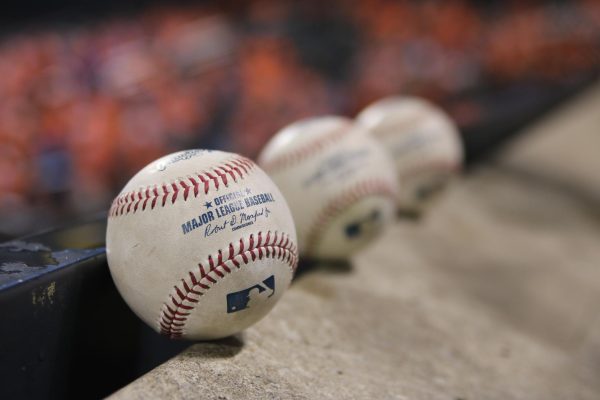 Major League Baseballs lined up together // Image by Lesly Juarez via Unsplash.