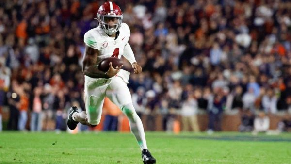 Jalen Milroe scrambles out for postive yardage. Image by Butch Dill via AP Photos.