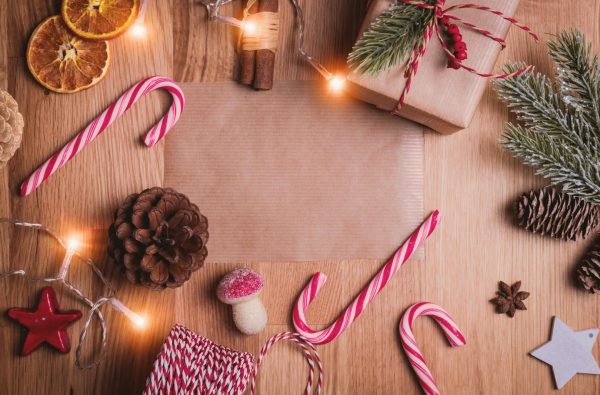 Image of a variety of Christmas themed objects: candy canes, lights, pinecones, etc. Photo by JESHOOTS.COM on Unsplash
  